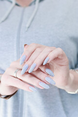 beautiful female hands with long nails light gray manicure
