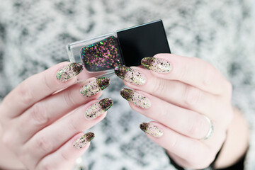 Woman's hands with long nails and white and black thermo © Tatiana