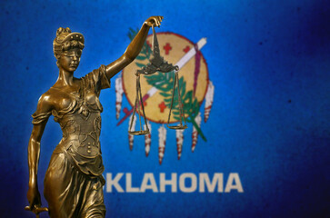 Lady Justice before a flag of Oklahoma
