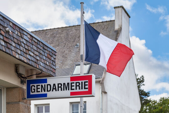 Tricolor gendarmerie sign and a French flag