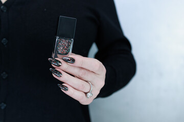Female hands with long nails and black manicure