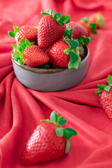 Fresh strawberries in ceramic bowl on white background