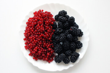 red currants and blackberries on a plate
