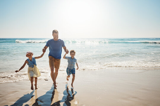 Running, holding hands and father with children at beach on holiday, vacation and tropical adventure. Family, travel and happy kids with dad by ocean for bonding, playing in waves and fun on weekend