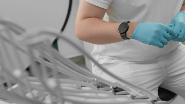 During a routine dental checkup, the dentist prioritizes patient safety and hygiene by utilizing medical instruments and protective gloves to uphold cleanliness standards in the clinic