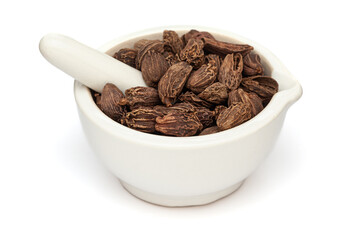 Close-up of Dry OrganicBlack cardamom (Amomum subulatum), in white ceramic mortar and pestle, isolated on a white background.