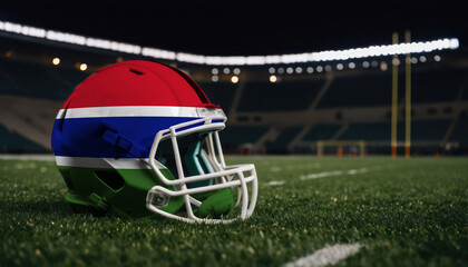 An American football helmet with the Gambia flag design sits on a field at night, under stadium lights