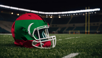An American football helmet with the Maldive flag design sits on a field at night, under stadium lights