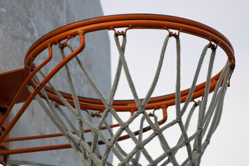 weathered basketball hoop and backboard up close © Elizabeth
