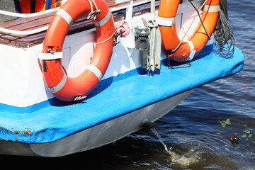 A boat with life preservers, perfect for water safety or rescue scenarios.