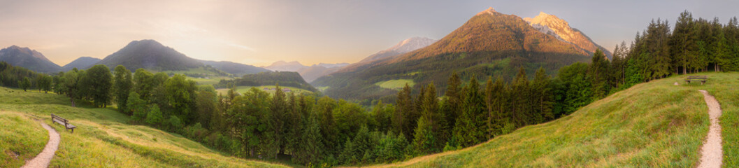 Meadow with road and bench during sunset in Berchtesgaden National Park