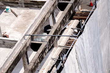 Unfinished construction structure, canvas to prevent dust spreading and disturbing others during construction.