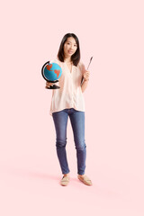 Asian Geography teacher with globe on pink background