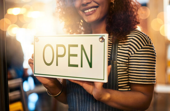 Window, cafe and woman hands with open sign for front door announcement, welcome and coffee shop offer. Business, glass and girl server with storefront information at restaurant for customer service