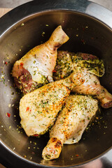 Raw chicken drumsticks with spices.