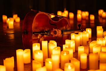closeup of violin with lots of candles © Ruslan
