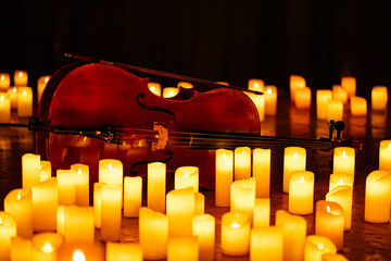 closeup of violin with lots of candles © Ruslan