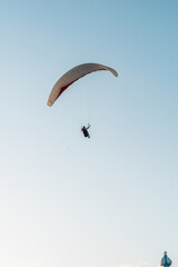 Paragliders in the sky. Man paragliding in a blue sky, on Cerro el Morro from Lechería, Venezuela