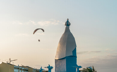 Paragliders in the sky. Man paragliding in a blue sky, on Cerro el Morro from Lechería, Venezuela