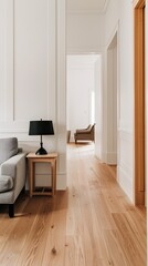 Fototapeta premium A modern, minimalist interior design with a white door, a grey armchair, and a grey sofa