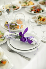Empty glasses and dishes on a wedding table with flowers
