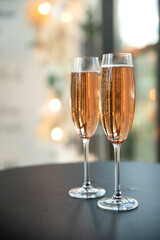 Two champagne glasses on a table close up