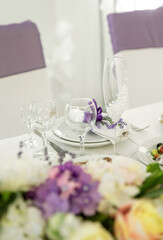 Empty glasses and dishes on a wedding table with flowers