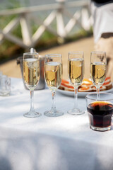 Glasses of champagne with ice on a festive table, close up