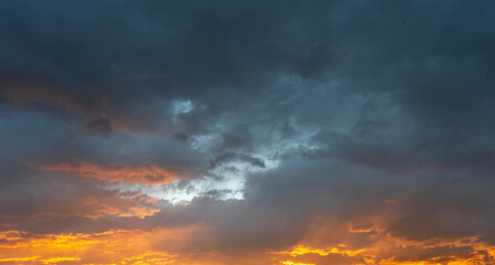 Sky background. Bright orange sunset sky with clouds.