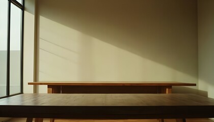 Empty wooden table. Empty wall in the background.