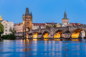 Charles Bridge (Karlův most) over Vltava river, illuminated in the evening, Prague, Czech Republic