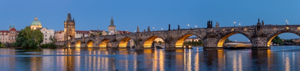 Charles Bridge (Karlův most) over Vltava river, illuminated in the evening, Prague, Czech Republic