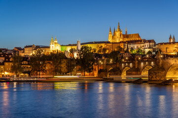 Charles bridge (Karlův most) and Hradcany castle hill over Vltava in the night, Prague, Czech Republic