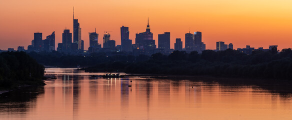 Panorama of Warsaw downtown skyline, Poland, over Vistula river during sunset