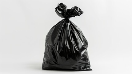 Black garbage bag on white background, studio shot. Waste management and cleanliness concept