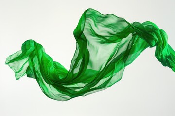 A woman wearing a green scarf and standing with her hair blown back by the wind