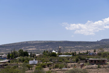 Obraz premium Mexico nature panorama, view from a viewpoint where you can see several hills, animals, plants, trees, agaves, clouds and even some houses