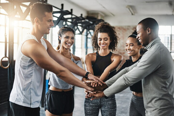 Gym, group and hands of people in huddle for fitness, diversity and support for workout community. Exercise, solidarity and team building with energy, men and women training together for healthy body