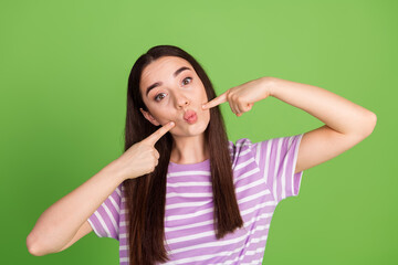 Fototapeta premium Photo portrait of lovely young lady point cheeks blow lips dressed stylish striped violet garment isolated on green color background