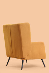 Stylish brown armchair on beige background, back view