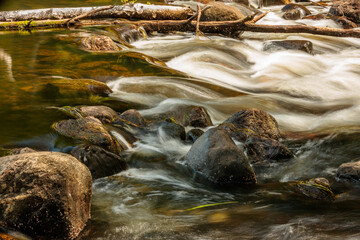 The Manitowish River, near Boulder Junction, Wisconsin flows quickly over and around the boulders within the river, creating an area that requires portaging for canoes and kyaks.