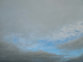 The sky is cloudy and the sun is not visible. The clouds are white and grey. Nature background.