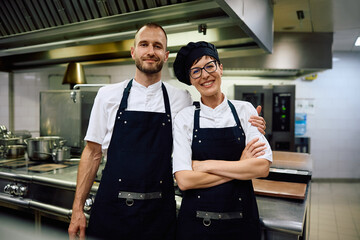 Portrait of happy chefs in  kitchen at restaurant looking at camera.