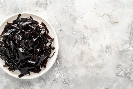 Dulse seaweed top view on white plate with space for text