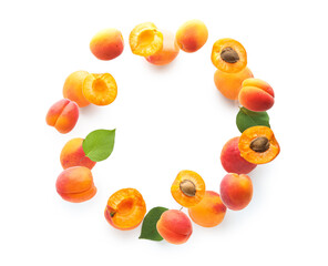 Frame made of flying apricots with leaves isolated on white background