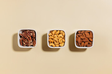 Various dry nuts in a small bowls, overhead view