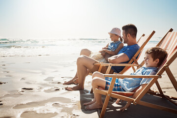 Family, beach and father with children on chair for holiday, vacation and relax on tropical island. Happy, travel and dad with kids by ocean for bonding, playing and fun outdoors in nature on weekend