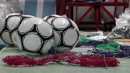 Worker Packing Finished Soccer Balls for Distribution and Sale at a Factory. Close-up Shot. 4K Resolution.