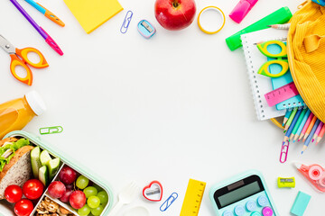 Frame of school supplies and a healthy lunch, perfect for educational themes and back-to-school...