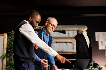 Fashion designers looking online for inspiration, trying to come up with artistic creative haute couture sartorial collection. Teamworking couturiers brainstorming upcoming menswear assortment